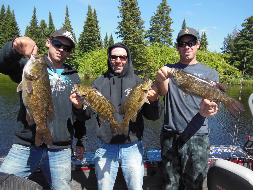 # anglers holding 4 manitoba smallmouth bass 