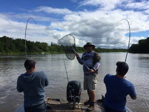 group fishign event 2 anglers with a double header fighting fish from the boat