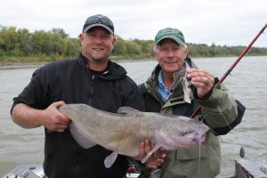 Blackwater outfitter Donovan Pearase shows off a big catch with Doug Stange in a boat