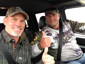 2 happy fishermen riding in a truck